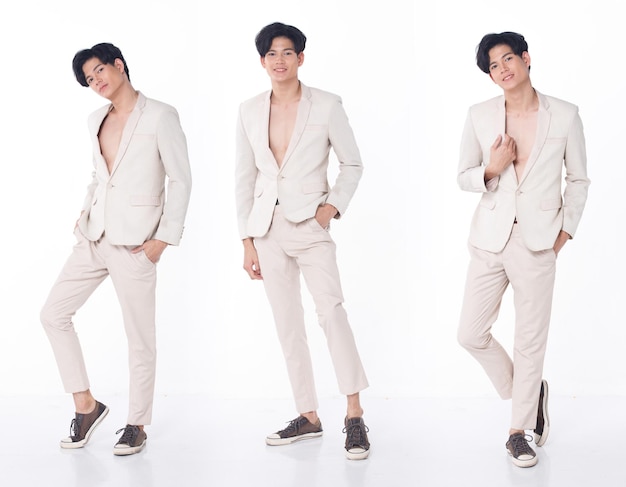 Full length Portrait 20s Asian Business man wear cream Formal Suit pants shoes for Gala Dinner and celebrate meeting. Young Smart Male stand confident feeling happy smile. White background isolated