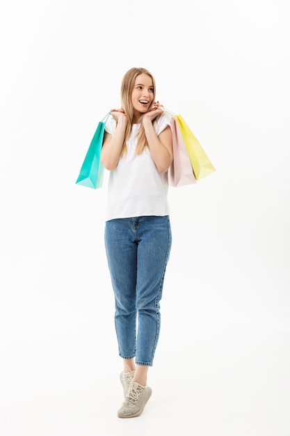 Full length portrait of a beautiful young woman posing with shopping bags