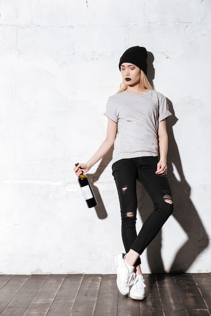 Full length portrait of Calm Hipster girl with wine