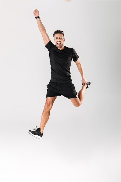 Full length portrait of a cheerful mature sportsman