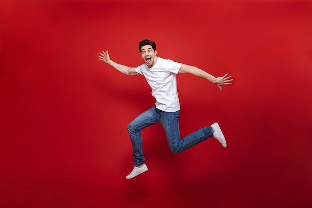 Full length portrait of an excited young man