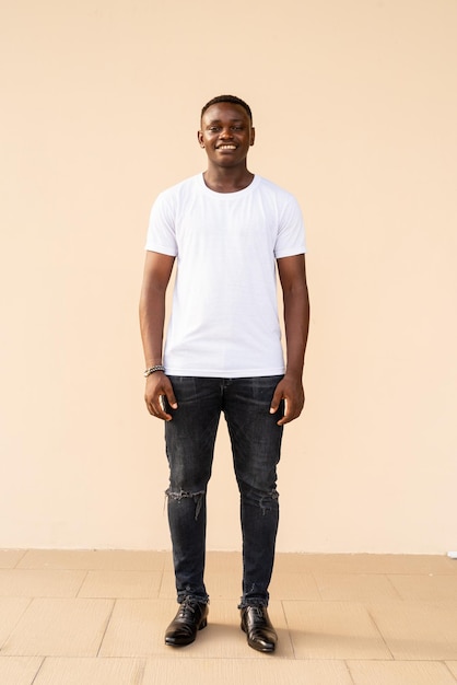 Full length portrait of handsome African man wearing white tshirt