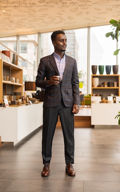 Full length portrait of handsome black businessman wearing suit