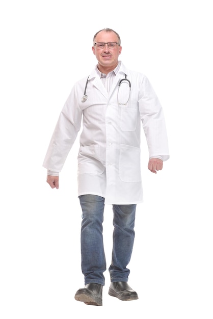 Full length portrait of male doctor walking isolated on white