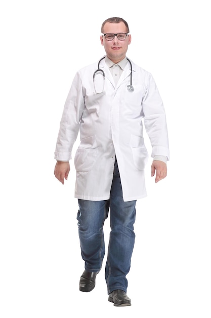 Full length portrait of young caucasian with stethoscope walking doctor