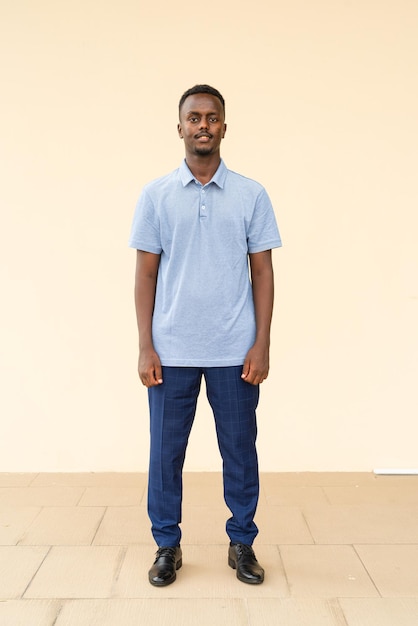 Full length portrait of young handsome black businessman