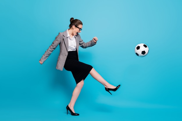 Full length profile side photo funky boss woman kick ball scream wear blazer skirt isolated blue color background