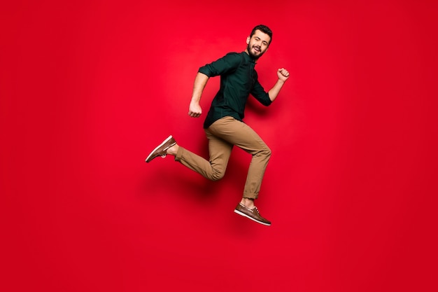 Full length profile side  of positive cheerful  guy jump run after black friday sales wear brown outfit sneakers 