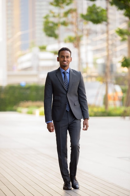 Full length shot of black businessman wearing suit in city