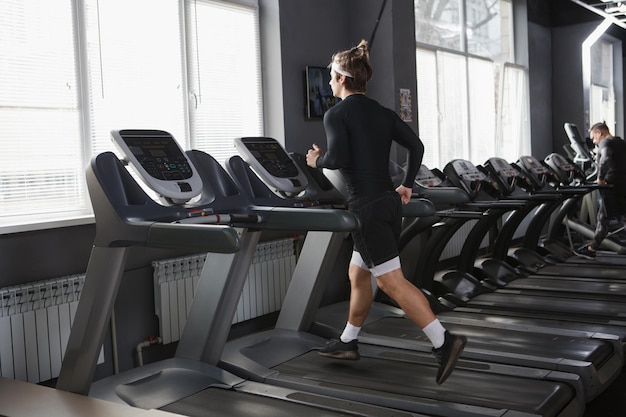 Full length shot of a sportsman running on a treadmill