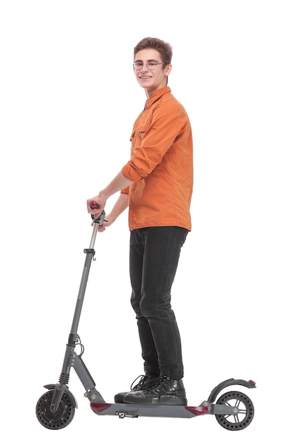 Full length side view portrait of an young man riding a scooter and looking awawy