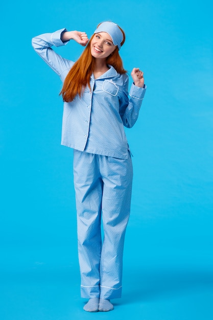 Full-length vertical shot cute and silly, teenage redhead girl, wearing lovely pyjama