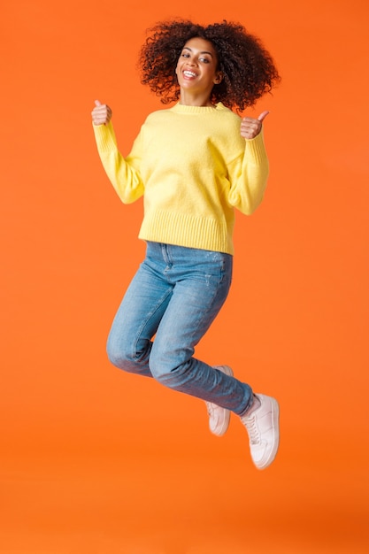 Full-length vertical shot happy and satisfied, carefree joyful african-american woman with afro, curly haircut