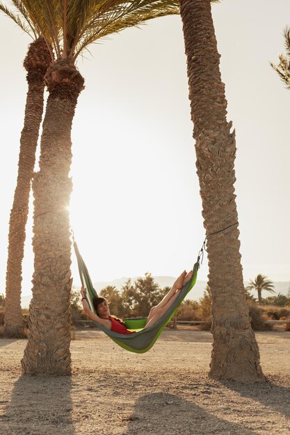 Photo full length of woman relaxing in hammock