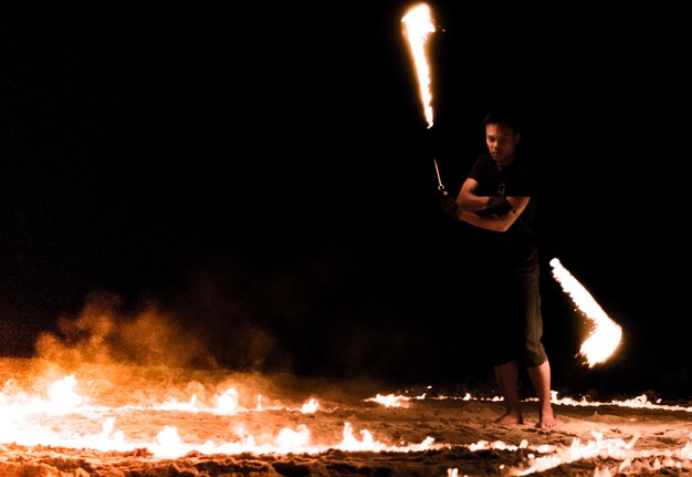 Photo full length of woman standing on fire at night