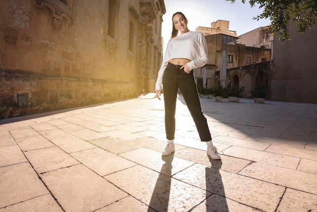 Full Length Woman Standing and smiling in the sunshine light