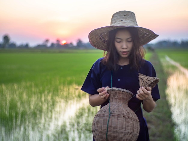 Full length of woman wearing hat standing on field