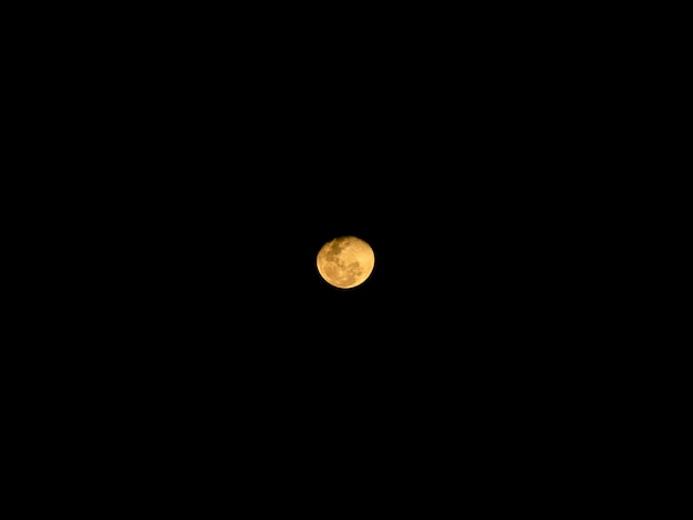 Full moon behind clouds at night