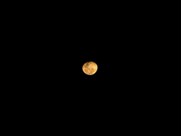 Full moon behind clouds at night