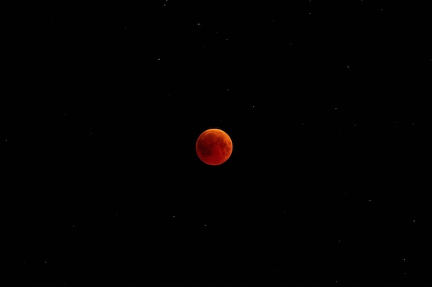 Full Moon eclipse. Earth satellite at night against the sky with stars.