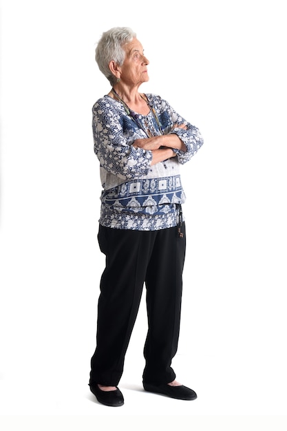 Full portrait of a senior woman side view,looking, arms crossed on white background