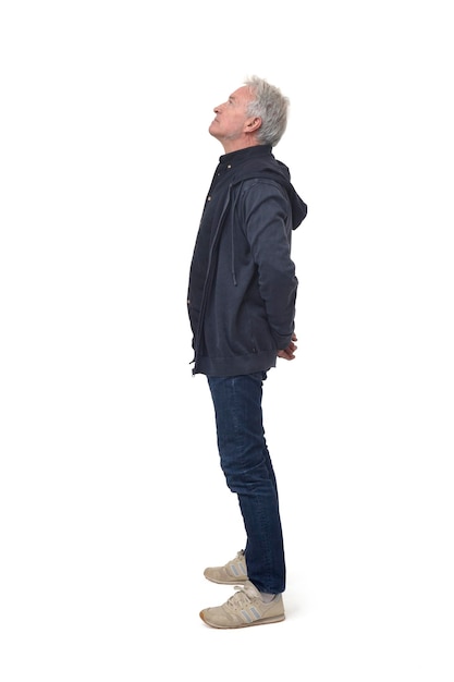 Full portrait of side view of a man looking up on white background