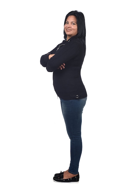 Full portrait of woman sideways on white,arms crossed and looking at camera