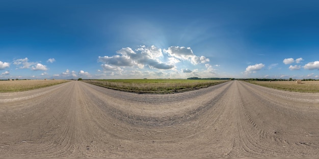 Full seamless spherical hdri 360 panorama view on no traffic gravel road among fields with overcast sky and white clouds in equirectangular projectioncan be used as replacement for sky in panoramas