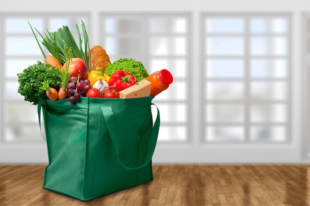 Full shopping  bag on kitchen background