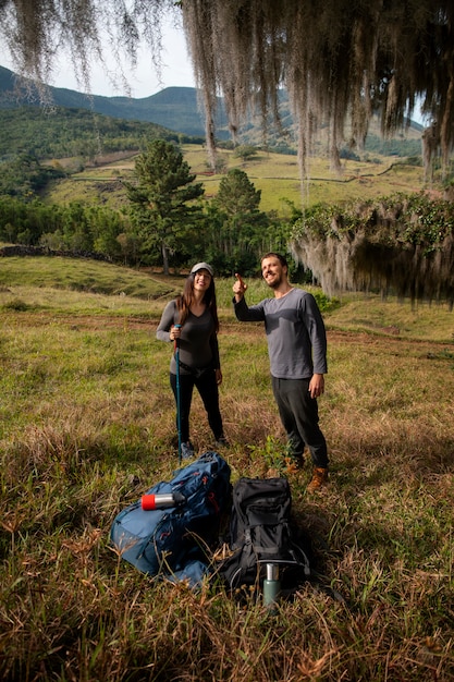 Full shot adventurous couple bivouacking