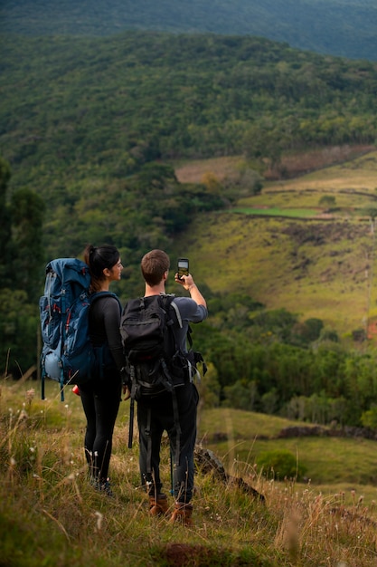 Full shot adventurous couple bivouacking