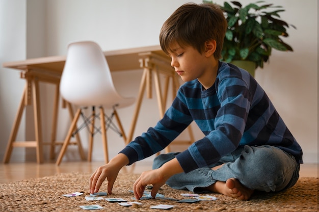 Full shot boy playing memory game