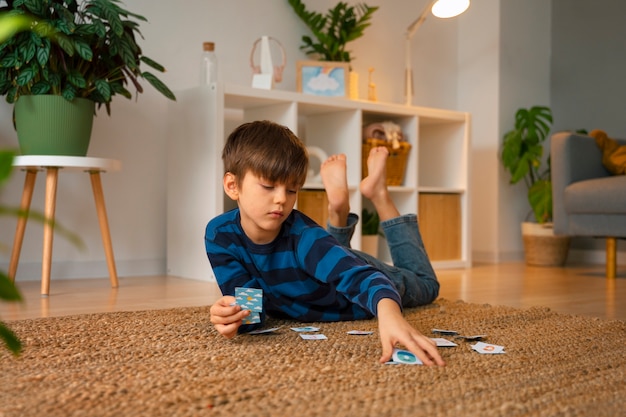 Photo full shot boy playing memory game