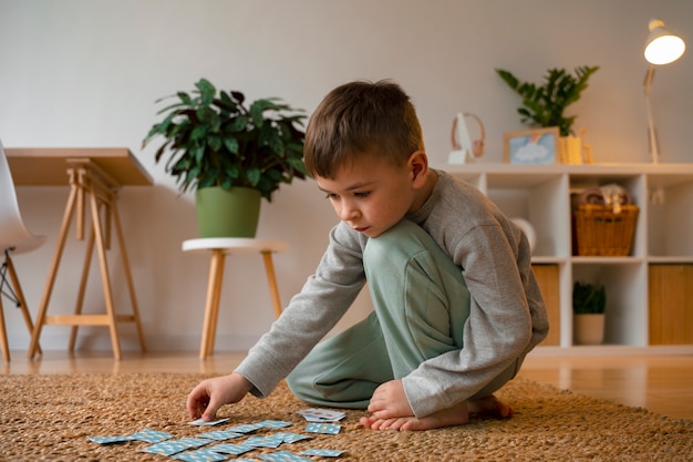 Full shot boy playing memory game