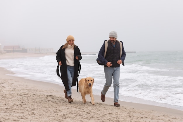 Full shot couple spending time at seaside