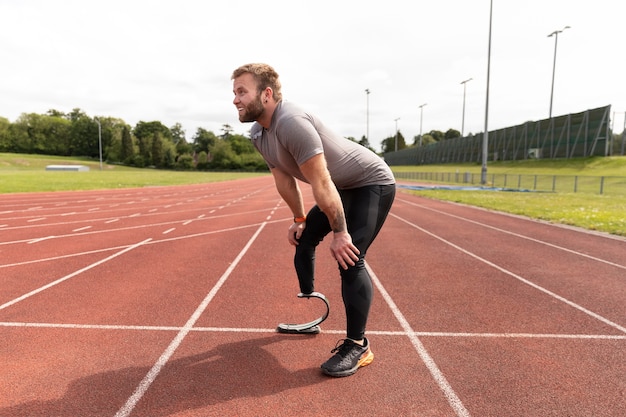 Full shot disabled man on running track