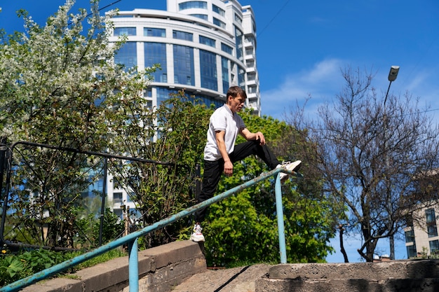 Full shot fit man doing parkour training