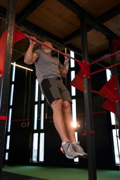 Full shot fit man working out at gym