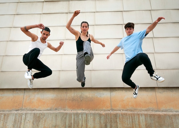 Full shot friends doing parkour