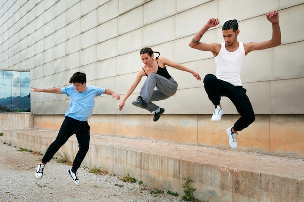 Full shot friends doing parkour