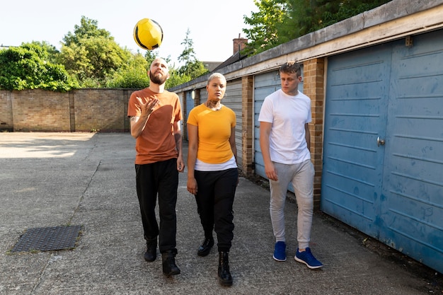 Full shot friends playing with ball