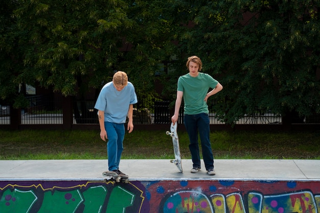 Full shot friends with skateboards outdoors