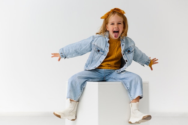 Full shot happy girl posing in studio