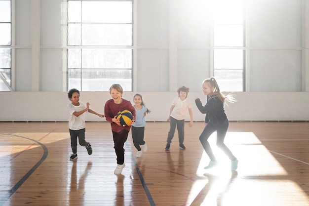 Full shot kids playing basketball together