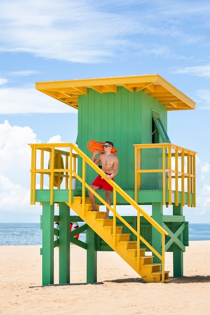 Full shot lifeguard on tower