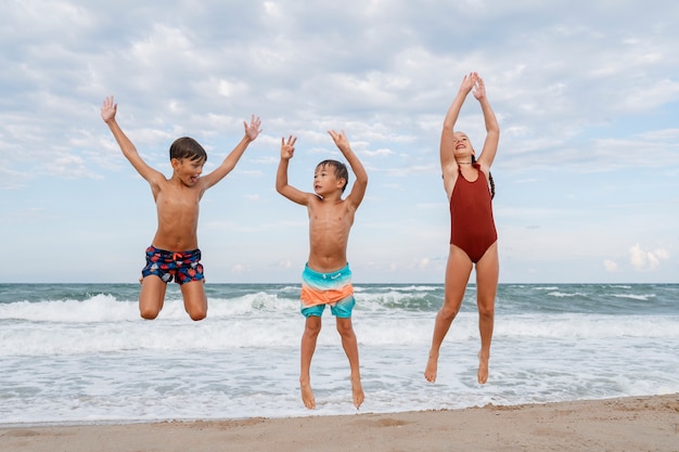 Full shot little kids having fun at the beach