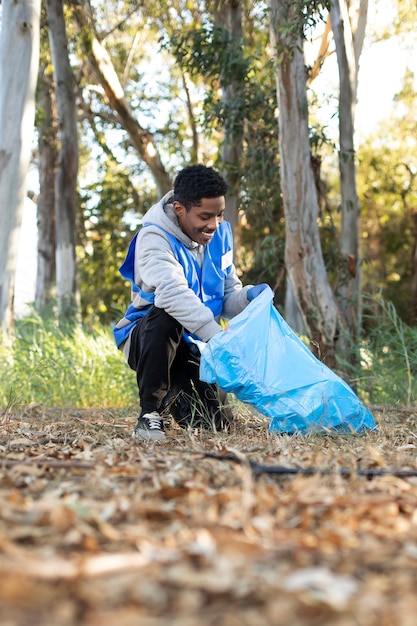 Full shot man collecting garbage