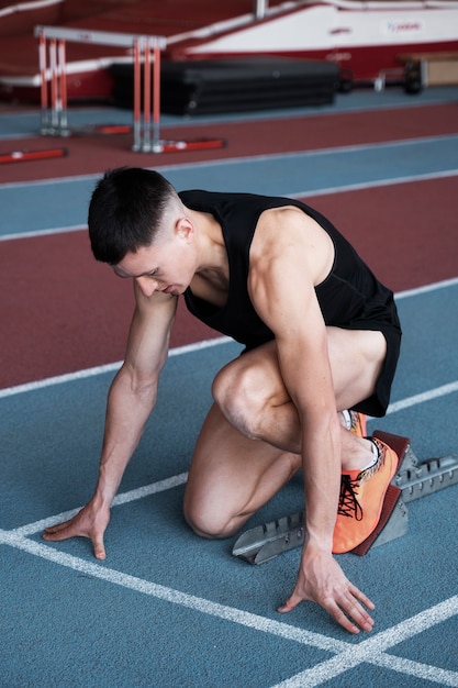 Full shot man at running starting line