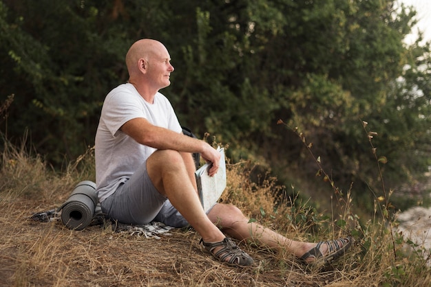 Full shot man sitting on grass