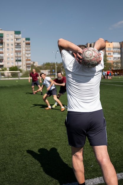 Full shot men playing soccer